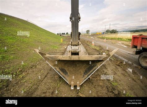 digging drainage ditch with excavator